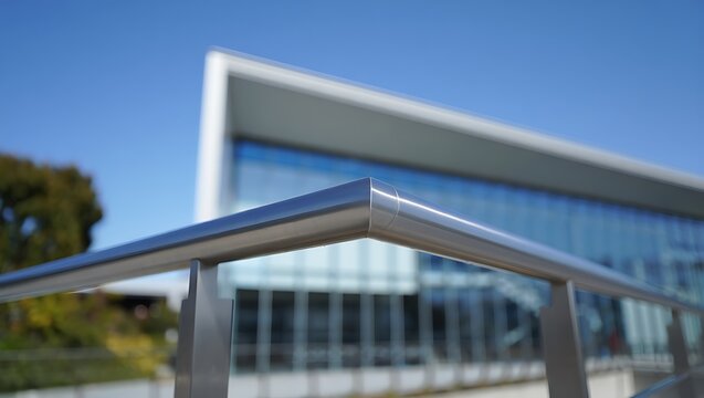 Modern stainless steel cable railing system enhancing balcony safety and contemporary architecture, featuring sleek metallic design, durable construction, and elegant outdoor urban residential appeal.