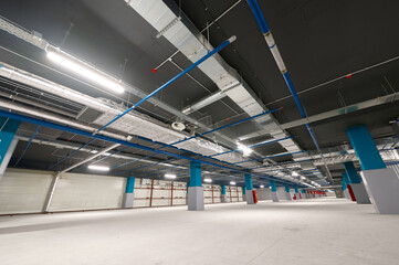 Spacious underground car park with modern lighting and wide open areas for vehicles
