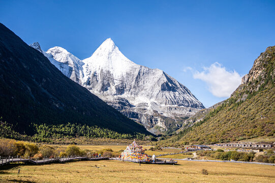 Daocheng Yading sacred mountains with Tibetan prayer flags and valley landscape in Sichuan China