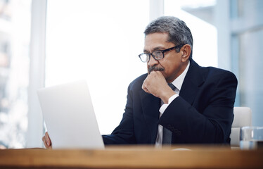 Obraz premium Businessman, thinking and accounting in office with laptop for investment decision, project ideas and proposal. Risk management, mature person and planning for financial strategy and problem solving
