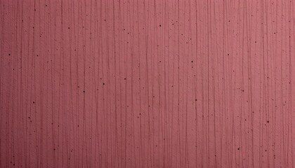 A close up of a textured wall with a pink hue, featuring an uneven pattern that could be interpreted as dots or speckles against a darker backdrop