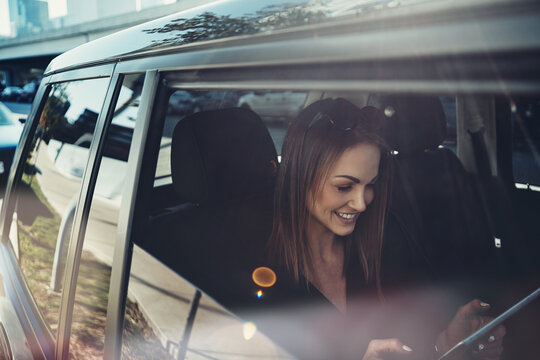 Travel, business woman and tablet in car for meeting schedule, route navigation and ride share. Cab service, happy professional and tech in backseat for online map, check location and morning commute
