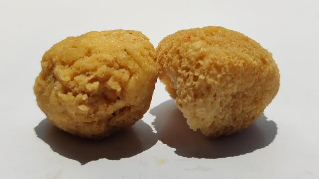 Tahu bulat, popular Indonesian street snack made from fried tofu balls, crispy outside and soft inside, freshly served as delicious local culinary food.