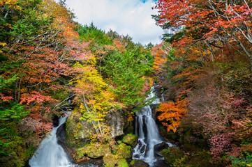 Ryuzu Waterfall or Ryuzu Cascades with autumn background is one of Landmark in Nikko to see autumn colors Nikko, Tochigi, Japan