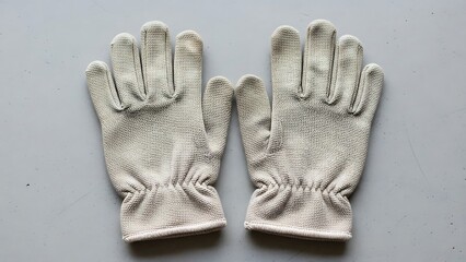 Industrial hand protection knitted work gloves on neutral studio surface