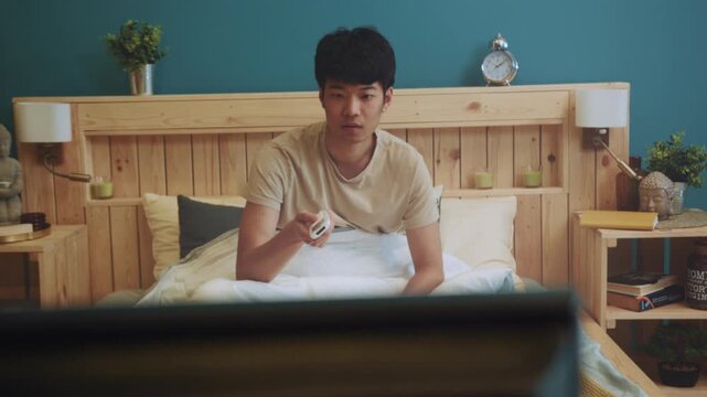 Man relaxing television, Man enjoying evening television time, Asian man relaxing and watching TV comfortably