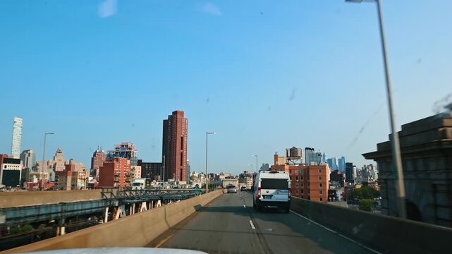 New York, USA, 5 August 2025: Driving along bridge toward Brooklyn and Manhattan skyline. Wide view of city buildings and road from a bridge crossing.