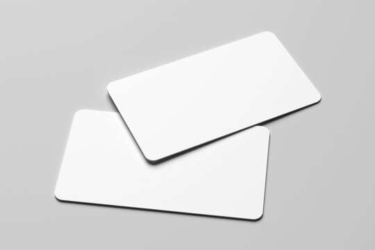 Mockup of two blank white business cards with rounded corners on a minimalist gray background