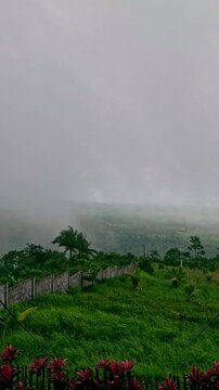 Hyperlapse of thick fog movements from the mountain range seen from the highlands during the monsoon season showing a mystical aesthetic