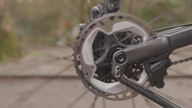 Close up of bike drivetrain with chainring spinning during outdoor ride