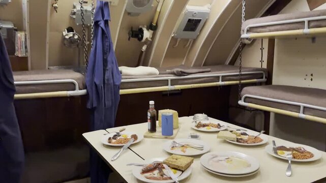 Explore life inside a submarine with detailed views of the crew bunks and dining setup on board.