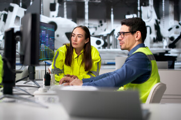 Fototapeta premium Team Of Diverse Car Factory Workers Monitor Assembly Line