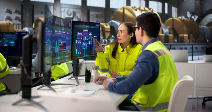 Engineers Operating Multiple Screens At Power Plant In Desktop Computer