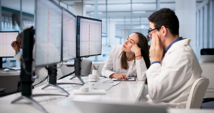 Doctors In Hospital Using Spreadsheets And Medical Codes