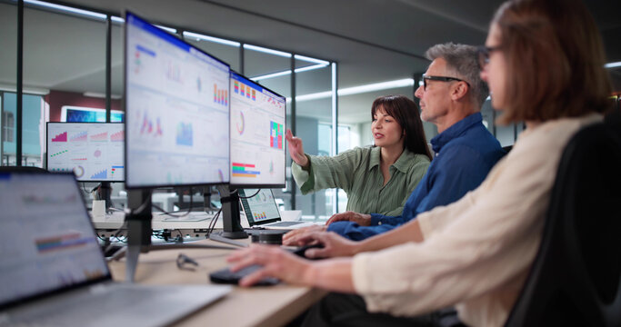 Multicultural Team Analyzing Performance Data Using KPI Dashboard