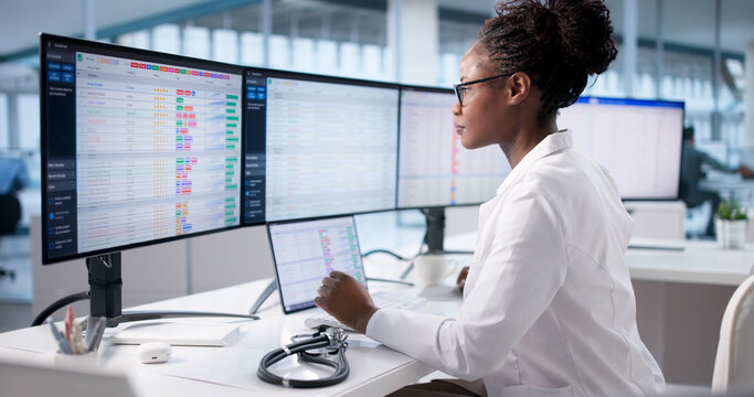 Black Businesswoman Managing Hospital Billing Using Computer Technology