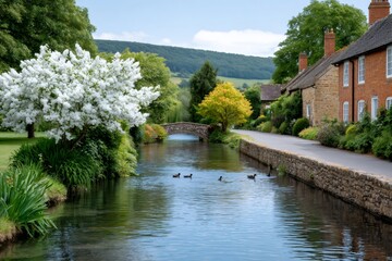 Fototapeta premium Cotswolds village with historic stone bridge and blooming tree