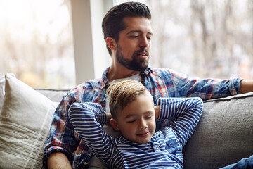 Father, son and nap on sofa with home, happiness and bonding with parent on weekend break. Dad, boy...