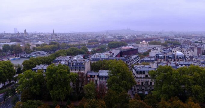 High angle view of Paris cityscape under overcast sky featuring Haussmann architecture