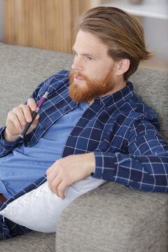young man using vapourizer as smoking alternative