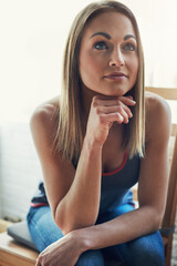 Naklejka premium Woman, happy and relax with thinking in home with decision, insight or inspiration in morning. Person, smile and perspective for reflection with memory, nostalgia or break in living room at apartment