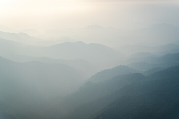 Fototapeta premium Foggy sunrise over the mountains from Ella rock in Sri Lanka