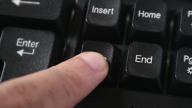 Pressing the Delete Button on a Computer Keyboard
