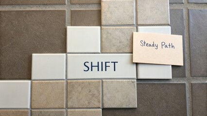 Obraz premium Inspirational Tile Artwork Featuring Shift Message with Notes on Steady Path in a Modern Design Setting