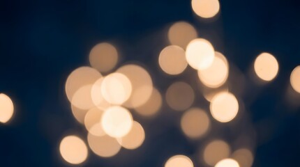 Fototapeta premium Blurry bokeh lights against a dark blue background.