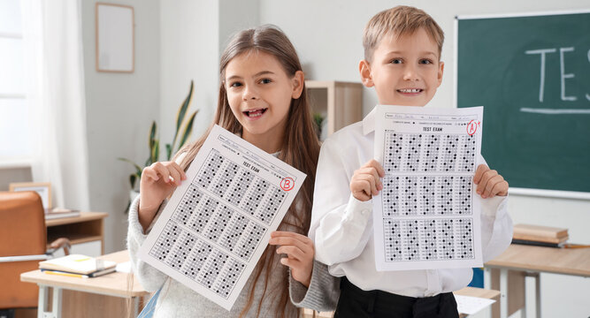 Happy pupils with results of test in classroom
