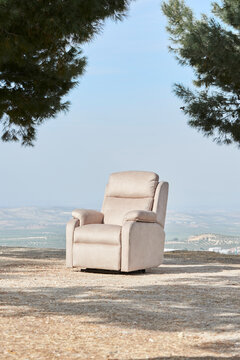 recliner armchair with panoramic mountain view framed by pine trees