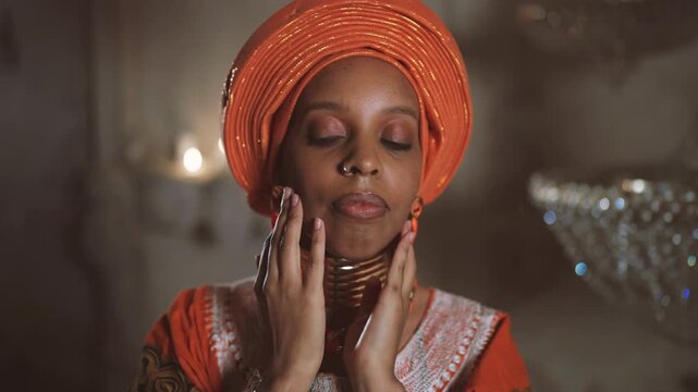 Portrait of beautiful african woman in traditional gown, lady looking at camera. Attractie african princess posing in her fabulous palace, explore culture of african continent, diversity of beauty