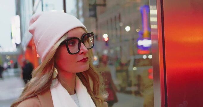 Woman Reflecting on City Street in Winter Attire