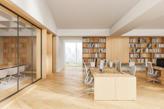 Modern interior design of open office space with wooden furniture, large bookshelves, and city view through glass wall in bright natural lighting. 3D Rendering
