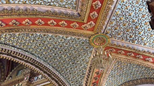 Intricate gold leaf details and geometric patterns on vaulted ceiling of Sanctuary of Guadalupe in Morelia. Ideal for travel documentaries, historical architecture, and religious heritage content