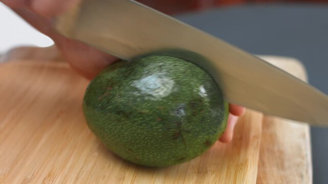 Cutting an avocado lengthwise with a sharp knife
