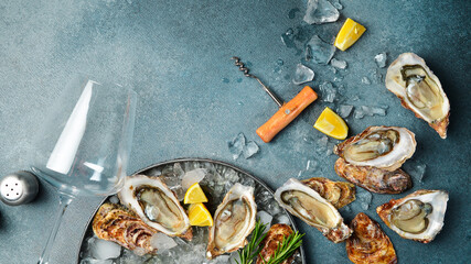 Dinner in restaurant. Wine glasses and oysters on a plate. Healthy sea food. Gourmet food, side view. © Yaruniv-Studio