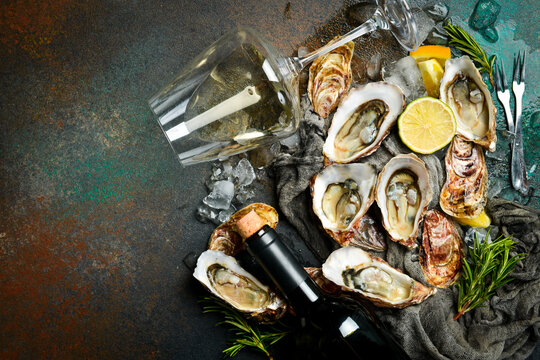 Fresh oysters and white wine. Healthy sea food. French Oyster dinner in restaurant. Seafood, Gourmet food. Flat lay.