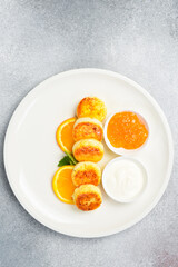 Breakfast. Cheese pancakes with orange jam and sour cream. Healthy meal.