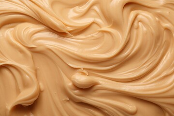 Fototapeta premium Peanut butter swirls creating a delectable creamy texture and background