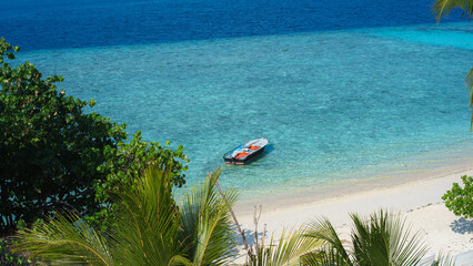 Small boat in tropical beach in Rasdhoo. Maldives 
