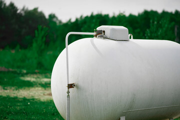 Large white propane tank supplies energy to home