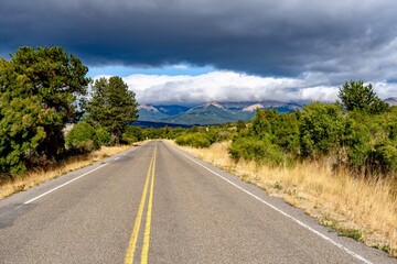 Naklejka premium Scenic Empty Road Near Esquel in Patagonia with Mountains and Dramatic Clouds