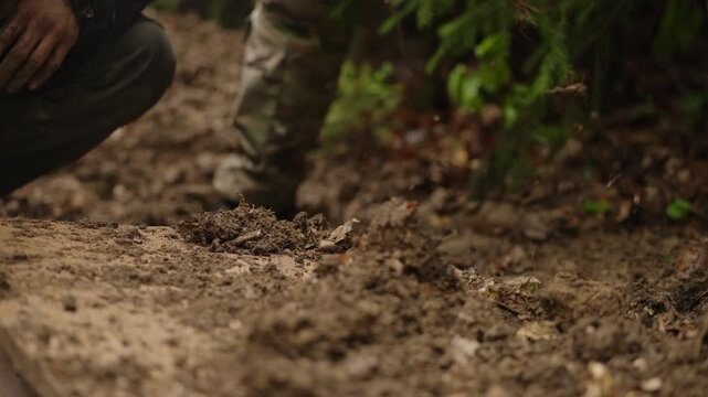 Men Burying Captive In The Pit After Interrogation IN The Forest. - closeup shot