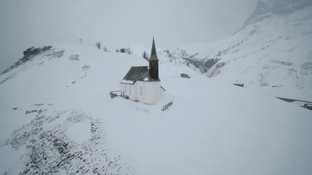 small chuch in the snowy alps, St. Jakobus am Simmel