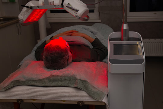 Facial LED Light Therapy Treatment in a Beauty Clinic with Red Light and Eye Protection