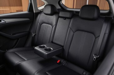 Obraz premium Car Interior: Luxurious Black Leather Back Seats with Fold-Down Center Armrest and Cup Holders