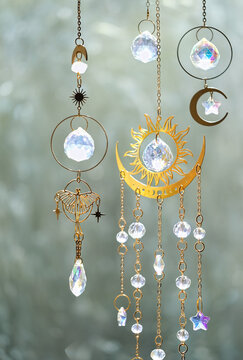 beautiful crystal suncatcher decorations close up on abstract blurred light background. Magic Ritual with crystal prism pendant. esoteric practice, meditation for positive spirit, harmony, relax.