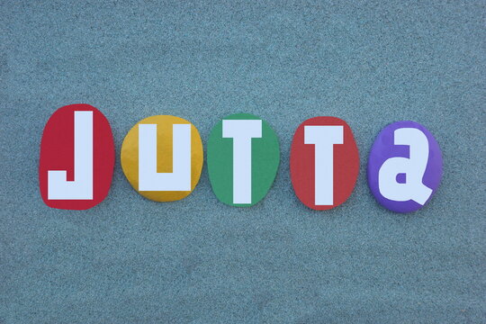 Jutta, feminine given name of Germanic origin, primarily used in Germany and Scandinavia as a medieval form of Judith. Creative composition with hand painted multi colored stone letters 