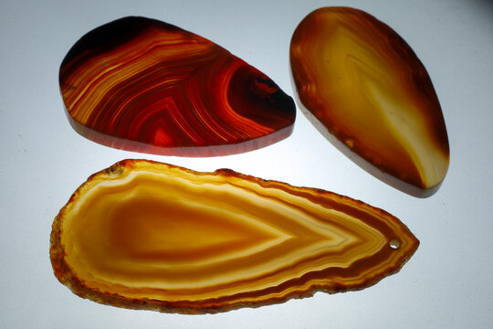 orange and red agate slices on white background